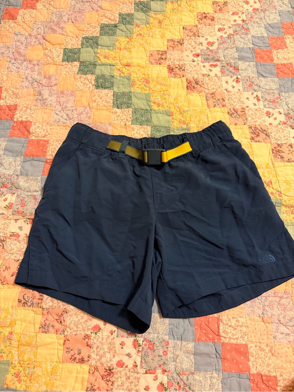 The North Face women’s Navy Outdoor Shorts with Yellow Belt